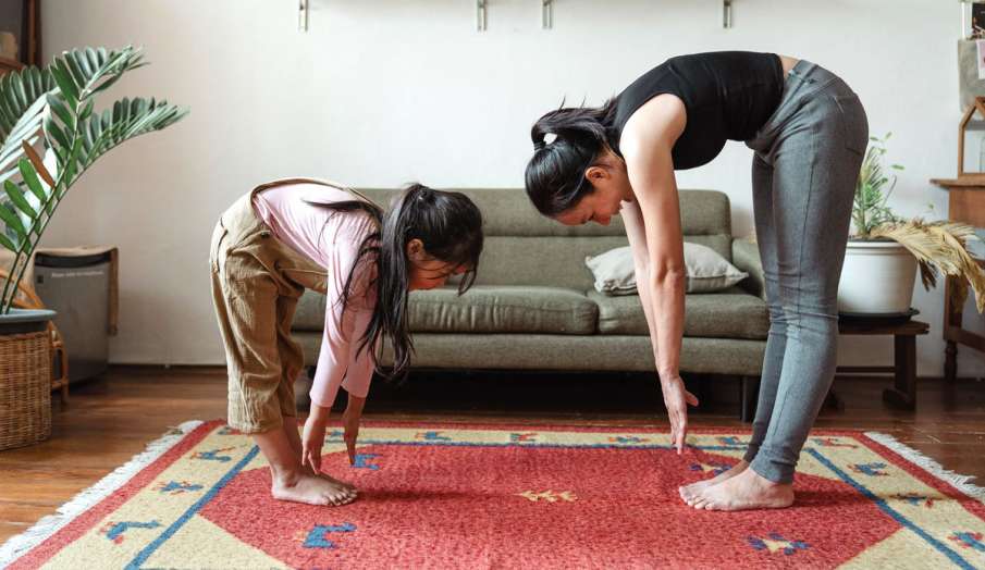 mom and daughter doing yoga exercise